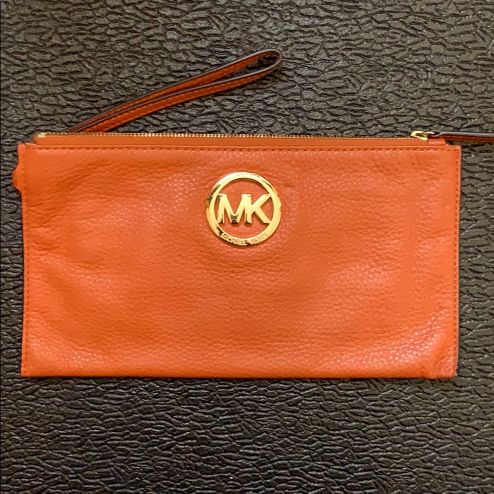 Burnt orange Michael Kors wristlet.